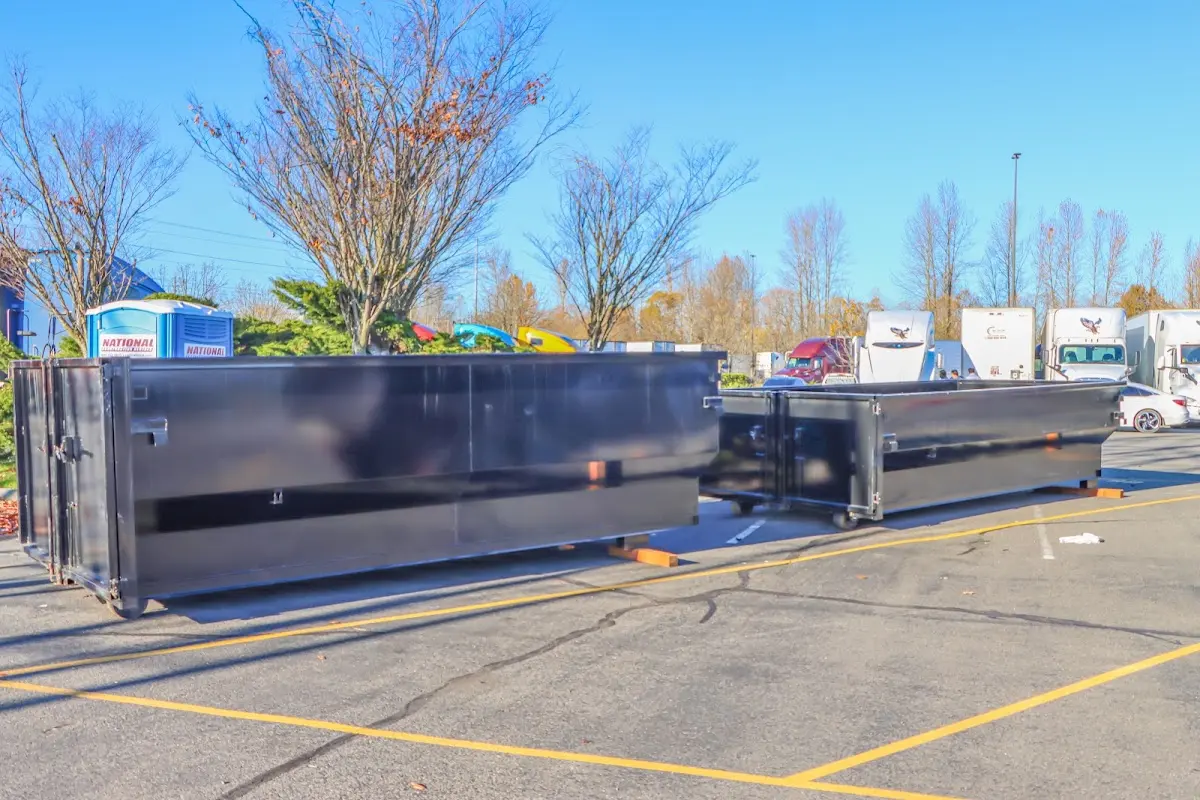 Professional dumpster rental service with roll-off container on residential driveway in King City